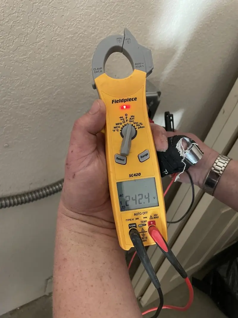 Voltage testing with clamp meter during Whole House Surge Protector in Dickinson